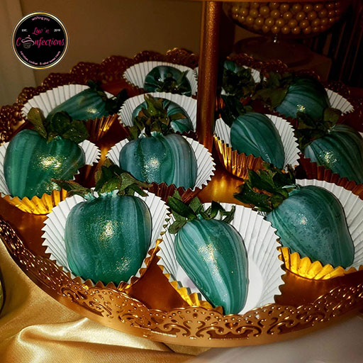 Emerald green and white swirled chocolate dipped strawberries with gold luster